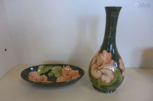 A Moorcroft green ground bottle vase, 27cm tall, and matching dish, both good, some crazing