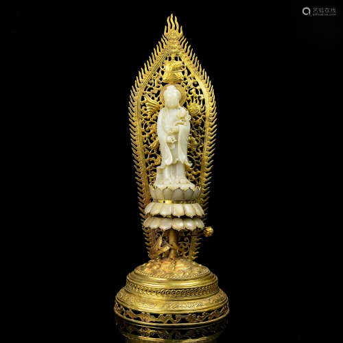 A Chinese Carved Jade Buddha with Gilt Bronze Stand