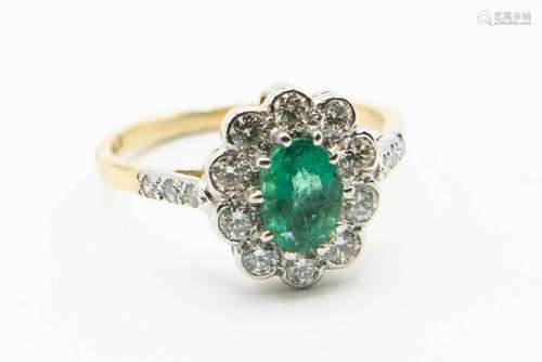 AN 18CT YELLOW GOLD EMERALD AND DIAMOND RING, the oval