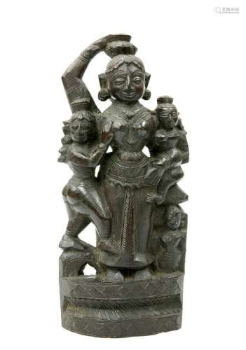 A CARVED WOODEN FIGURE OF A DEITY AND ATTENDANTS.