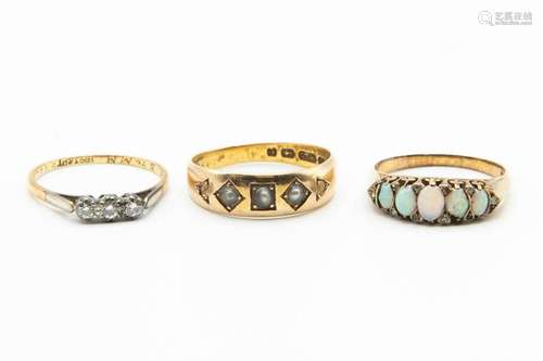 THREE GOLD GEM SET RINGS, one set with three seed pearl