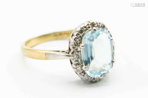 AN AQUAMARINE AND DIAMOND RING, the oval cut aquamarine