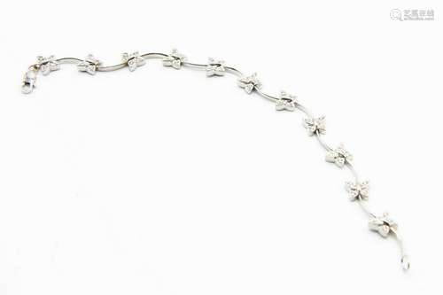 AN 18CT WHITE GOLD AND DIAMOND SET BRACELET, the eleven