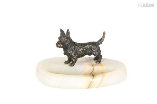 A PATINATED BRONZE MODEL OF A TERRIER MOUNTED ON AN