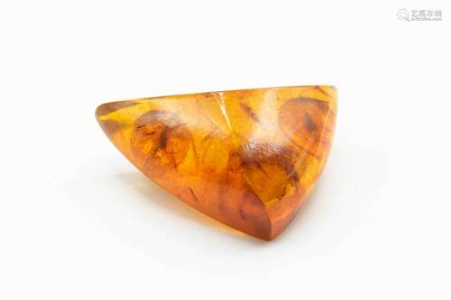 A RUSSIAN AMBER BROOCH, of abstract triangular form on