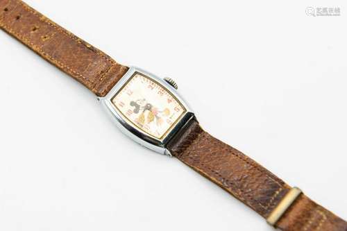 A MICKEY MOUSE STRAP WATCH. Tonneau shaped dial signed