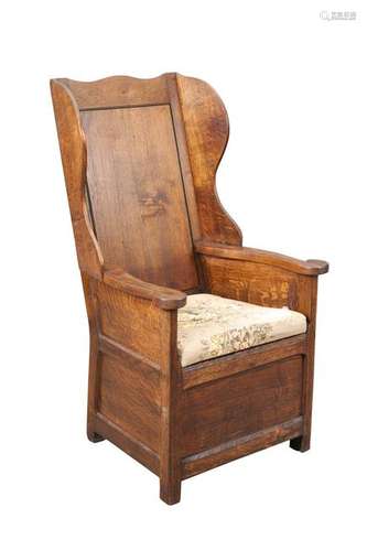 A GEORGE III OAK LAMBING CHAIR, with wing-back and