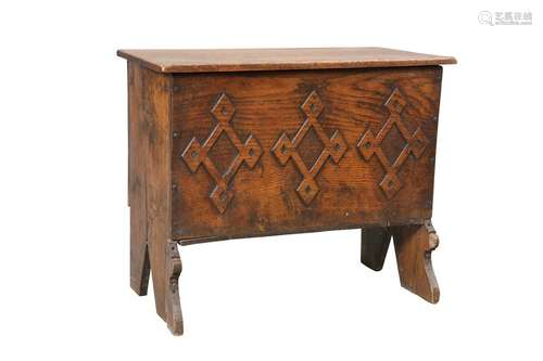 A SMALL BOARDED OAK CHEST, the lid with chip carved