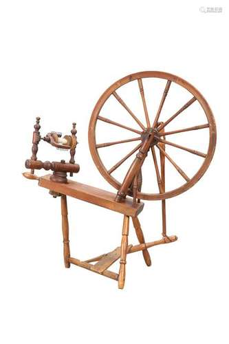 A VICTORIAN PINE SPINNING WHEEL, of characteristic form;