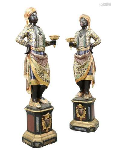 A PAIR OF ITALIAN POLYCHROME CARVED WOODEN TORCHERE