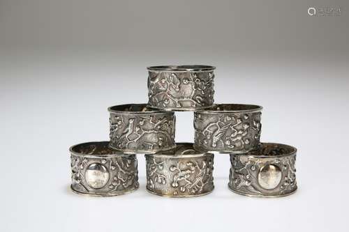 A SET OF SIX CHINESE EXPORT WHITE METAL NAPKIN RINGS,