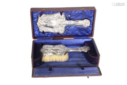 A CASED EDWARDIAN SILVER-MOUNTED HAND MIRROR AND BRUSH