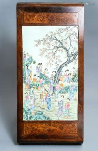 A large Chinese famille rose plaque inset in a wooden