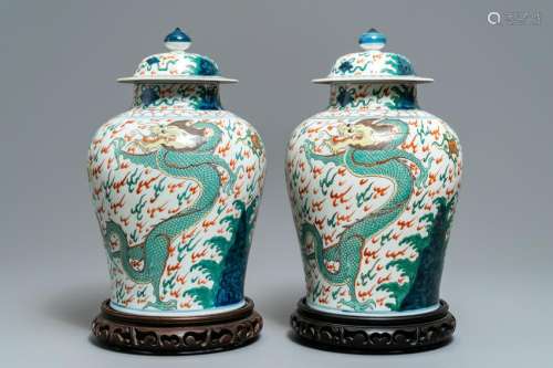 A pair of wucai-style vases and covers with dragons,