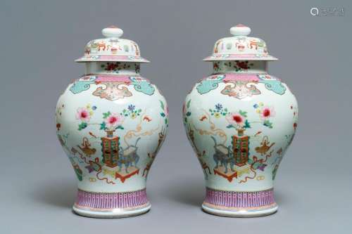 A pair of Chinese famille rose vases and covers with