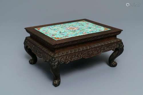 A Chinese carved wooden stand with famille rose plaque,