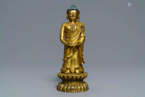 An inscribed Chinese gilt bronze figure of Buddha