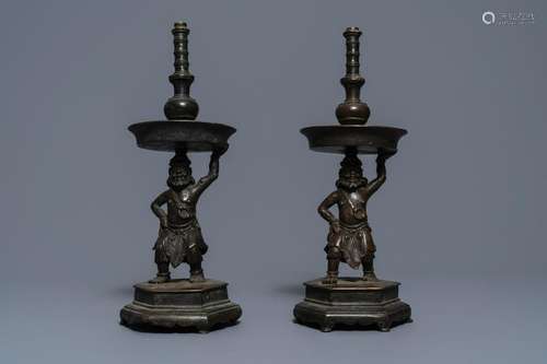 A pair of Chinese bronze candlesticks, Ming