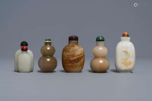 Five Chinese celadon and russet jade snuff bottles,
