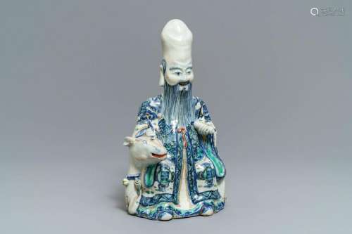 A rare Chinese wucai figure of Shoulao seated on a