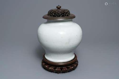 A Chinese monochrome white vase with a wooden cover and