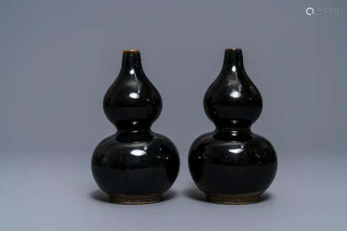 A pair of Chinese dark brown-glazed double gourd vases,