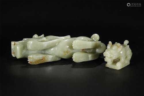 A CELADON JADE CARVING OF A BEAST SPECIMAN