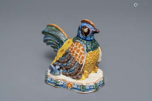 A polychrome Dutch Delft group of a hen with chickens,