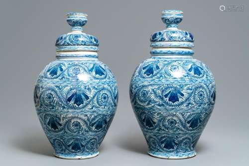 A pair of large Dutch Delft blue vases and covers, 18th