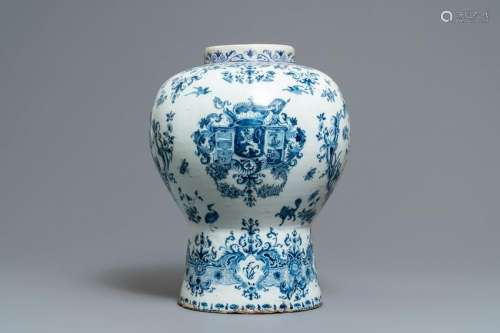 A large Dutch Delft blue and white vase with the arms