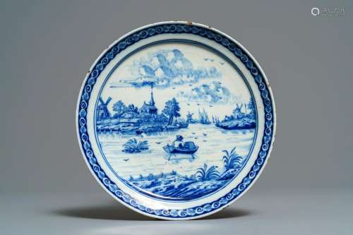 A Dutch Delft blue and white plate with a fine river