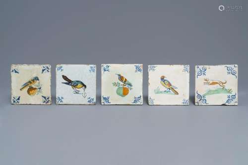 Five polychrome Dutch Delft tiles with birds and a dog,