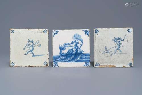 Three Dutch Delft blue and white putti and seacreature
