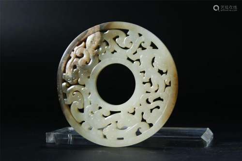 A PALE CELADON/RUSSET JADE CARVED BI DISK