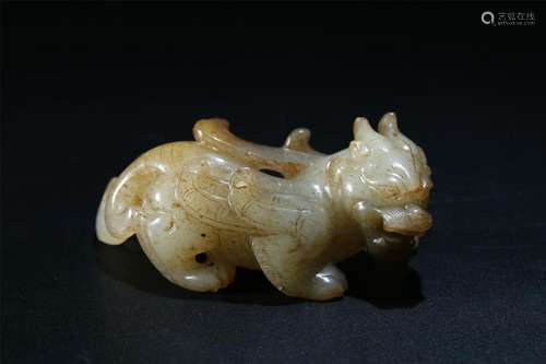 A PALE CELADON/RUSSET JADE CARVING OF BEAST