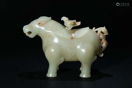 A PALE CELADON/RUSSET JADE CARVED BEAST FIGURE