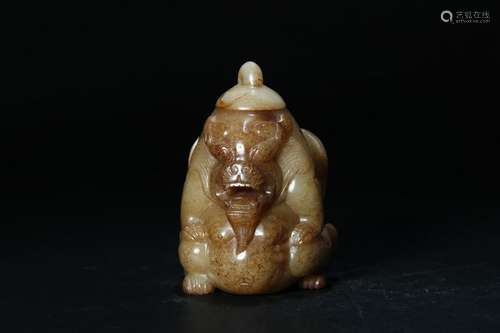 A PALE CELADON/RUSSET JADE CARVING OF BEAR