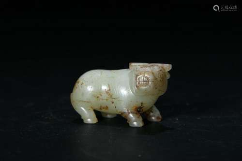 A PALE CELADON/RUSSET JADE CARVING OF A COW