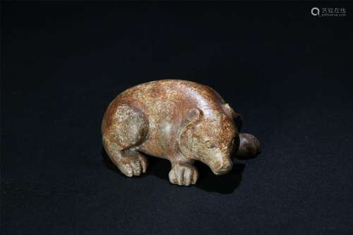 A PALE CELADON/RUSSET JADE CARVED BEAR FIGURE