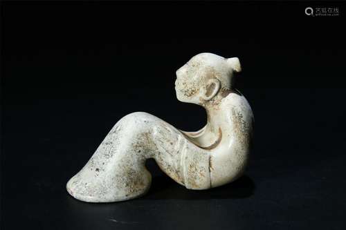 A PALE CELADON JADE CARVED SEATED SERVANT FIGURE