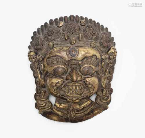 Bhairava-MaskeNepal. Bronze, vergoldet. Zornvolle Manifestation Shivas mit Krone aus vier Schädeln