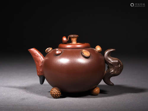 A YIXING-GLAZED HUNDRED FRUITS TEAPOT, 18TH CENTURY