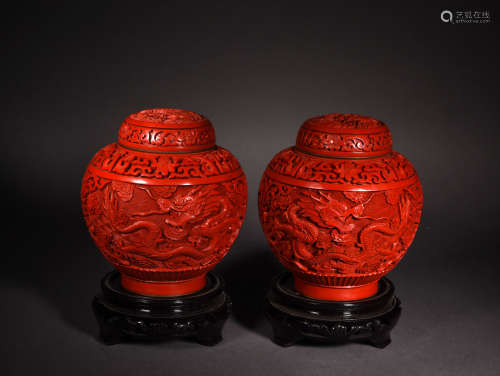 A PAIR OF CINNARBAR LACQUER DRAGON AND CLOUDS JARS AND COVERS, REPUBLIC PERIOD
