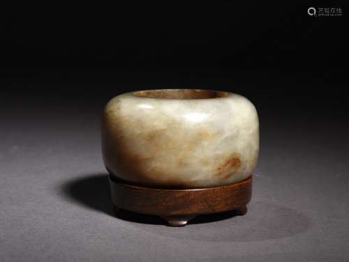 A CREAM WHITE AND RUSSET JADE WASHER, 16TH CENTURY