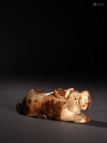 A CREAMY WHITE AND RUSSET JADE ARCHAISTIC FORM BEAST, HAN DYNASTY