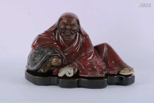 A CHINESE RED GLAZED FIGURE OF LUOHAN , REPUBLICAN