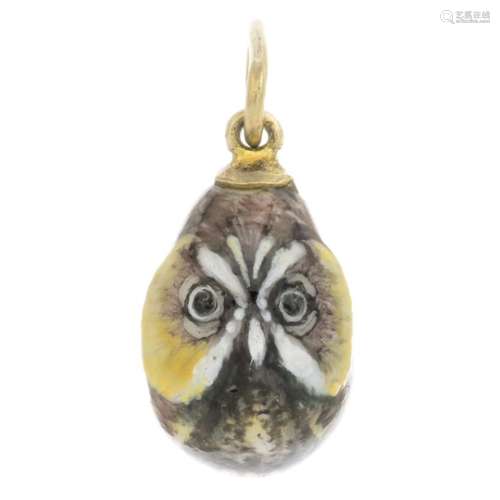 An early 20th century enamel egg pendant, painted to depict an owl.Length 2.3cms.