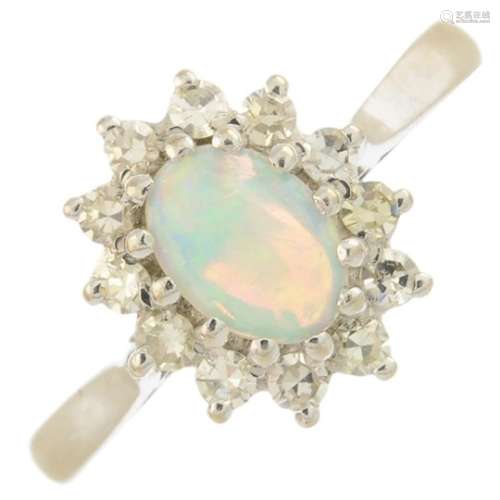 An 18ct gold opal and diamond cluster ring.Approximate opal dimensions 7.1 by 5.8 by 2.4mms.