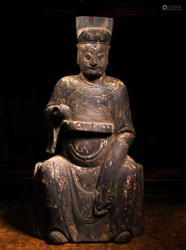 A CARVED WOOD FIGURE OF SEATED MALE, 17TH CENTURY