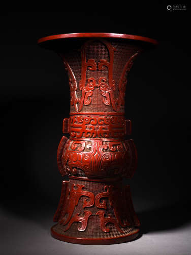 A CARVED CINNABAR LACQUER ARCHAISTIC FORM BEAKER VASE, 18TH CENTURY